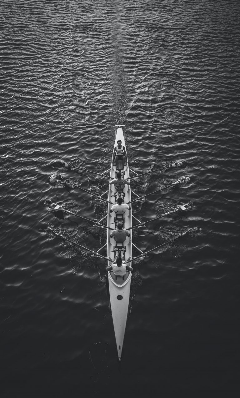 people riding boat on body of water photo